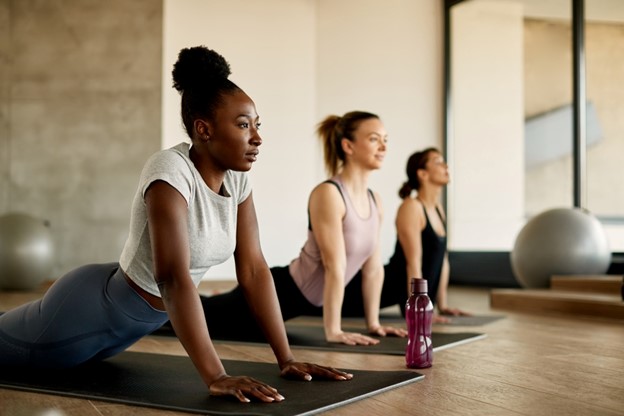 People doing yoga in yoga studio