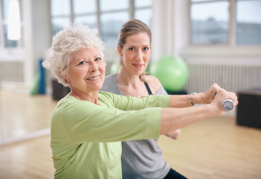 An older woman does some stretching to help mobility